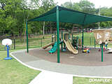 Shaded playground installed with poured-in-place rubber surfacing