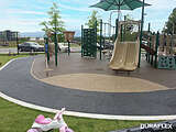 Park playground installed with IPEMA certified poured-in-place rubber surfacing