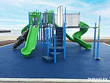 Blue poured-in-place rubber surfacing underneath a green playset