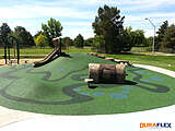 Playground mound with poured-in-place rubber surfacing installed