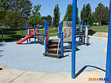 Grey poured-in-place rubber surfacing at a playground