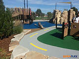 Rubber playground surface around a playset