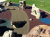 City park with rubber playground surfaces of various colors